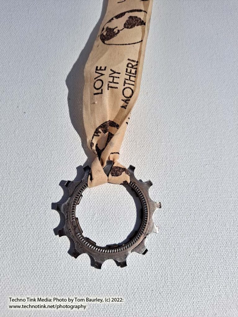 A Medal made from a bike gear and Love Thy Mother ribbon