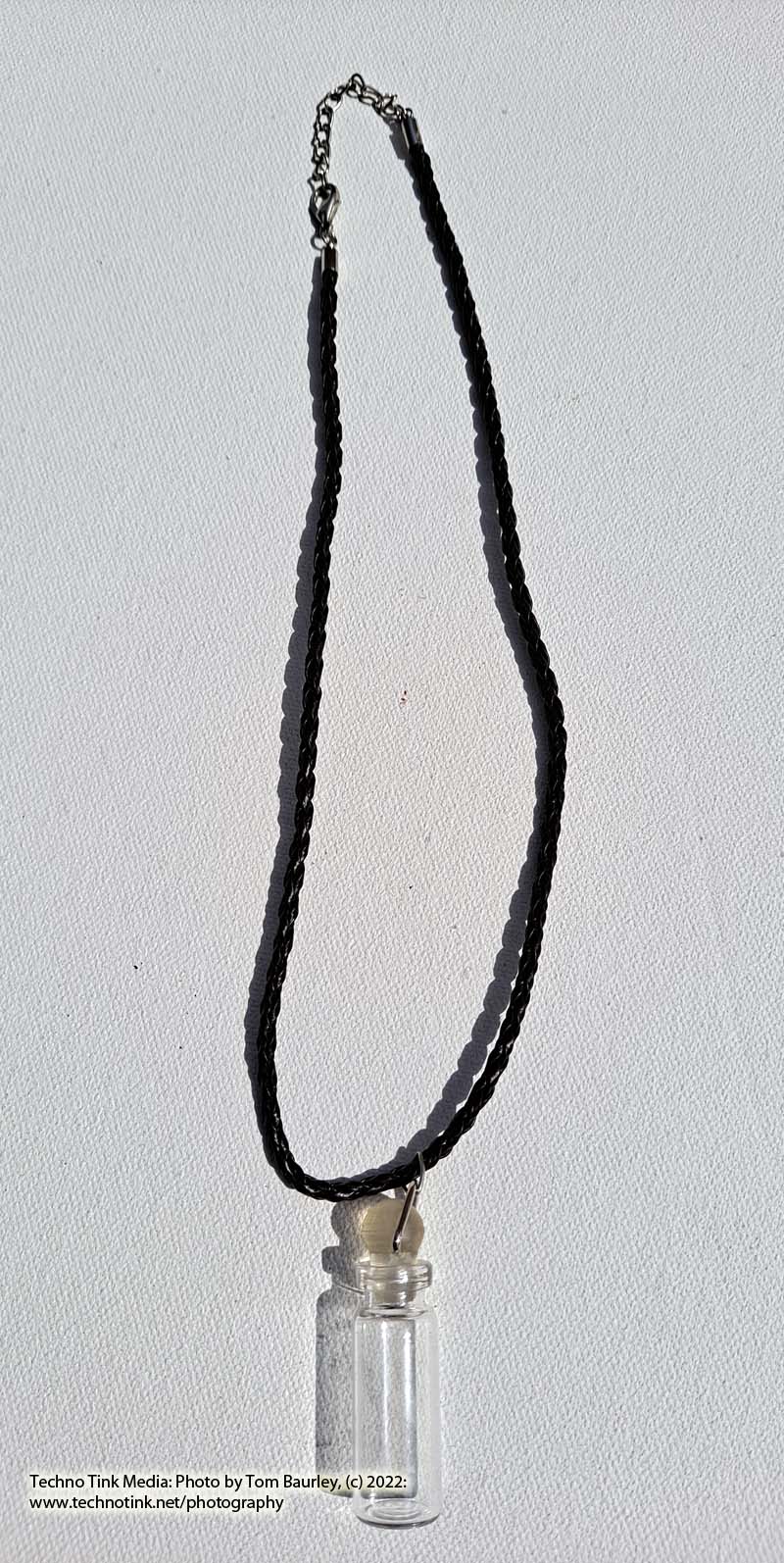 Glass vial with stopper pendant on brown braided leather cord necklace - Image 2