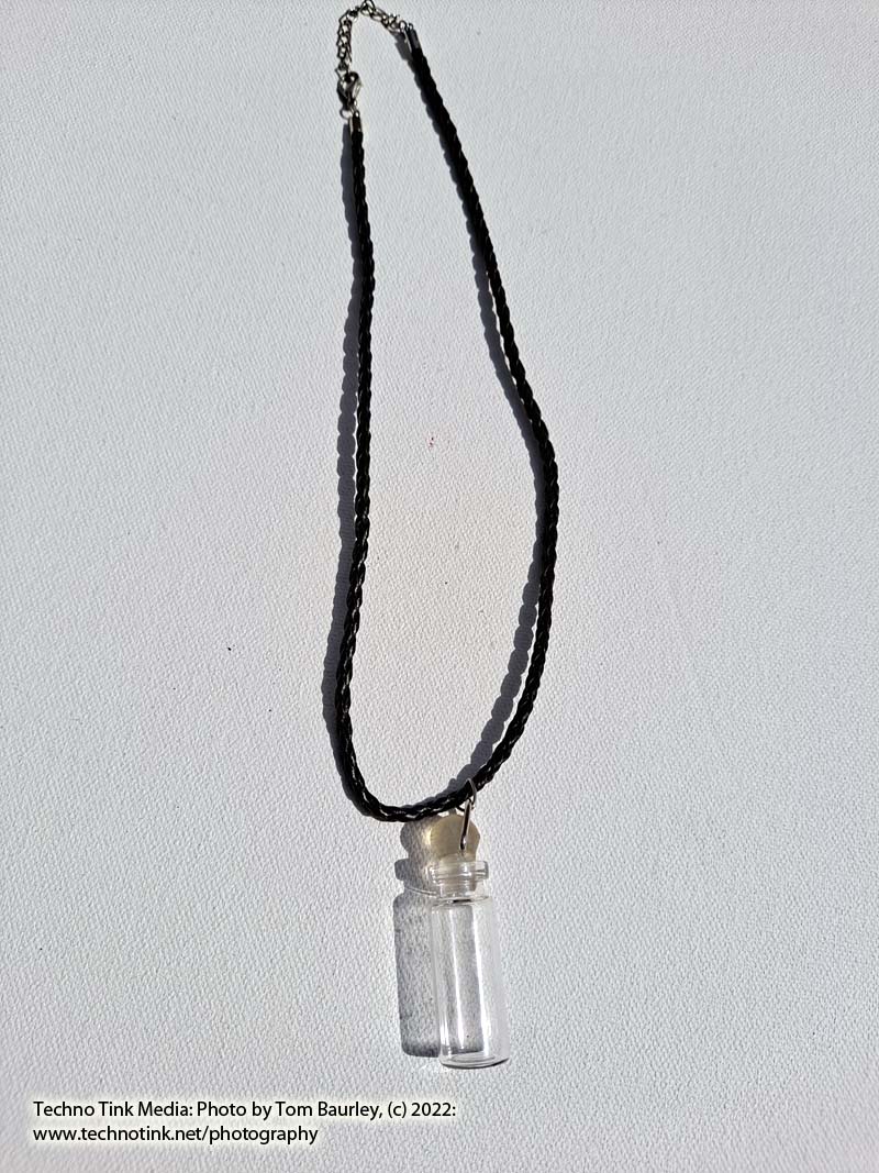 Glass vial with stopper pendant on brown braided leather cord necklace - Image 3