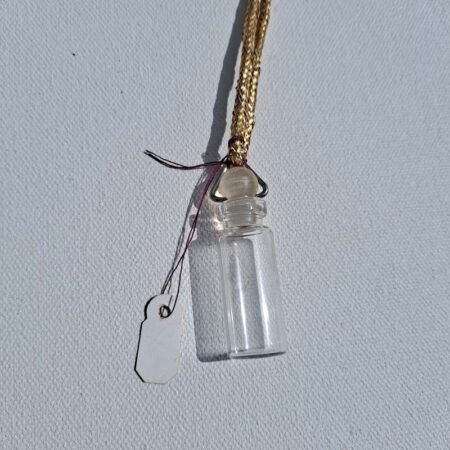 Glass vial with stopper pendant on gold color cord