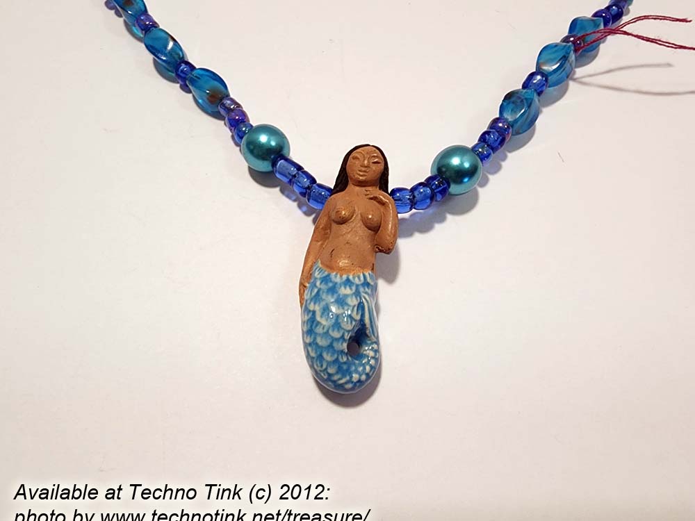 Black-haired dark skin Mermaid Clay Pendant on bright blue ball beaded necklace