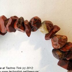 string of medium reddish brown chips (possibly jasper) 34" x1/8"